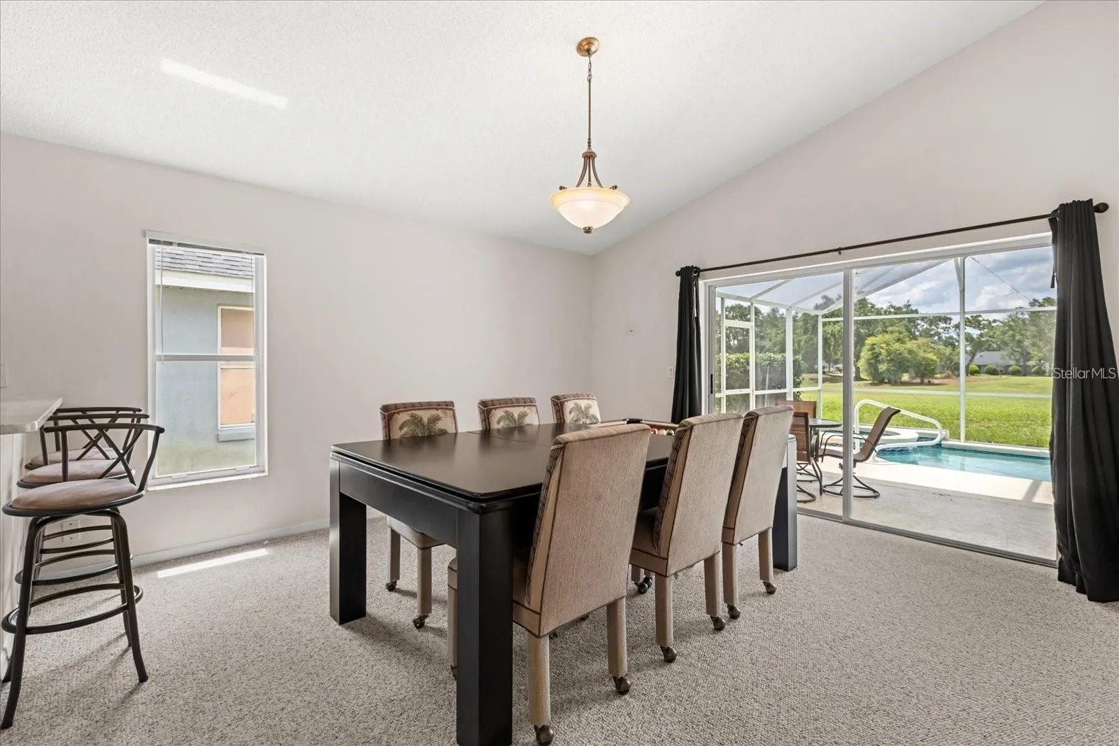 Dining area overlooking the pool, perfect for indoor outdoor entertaining