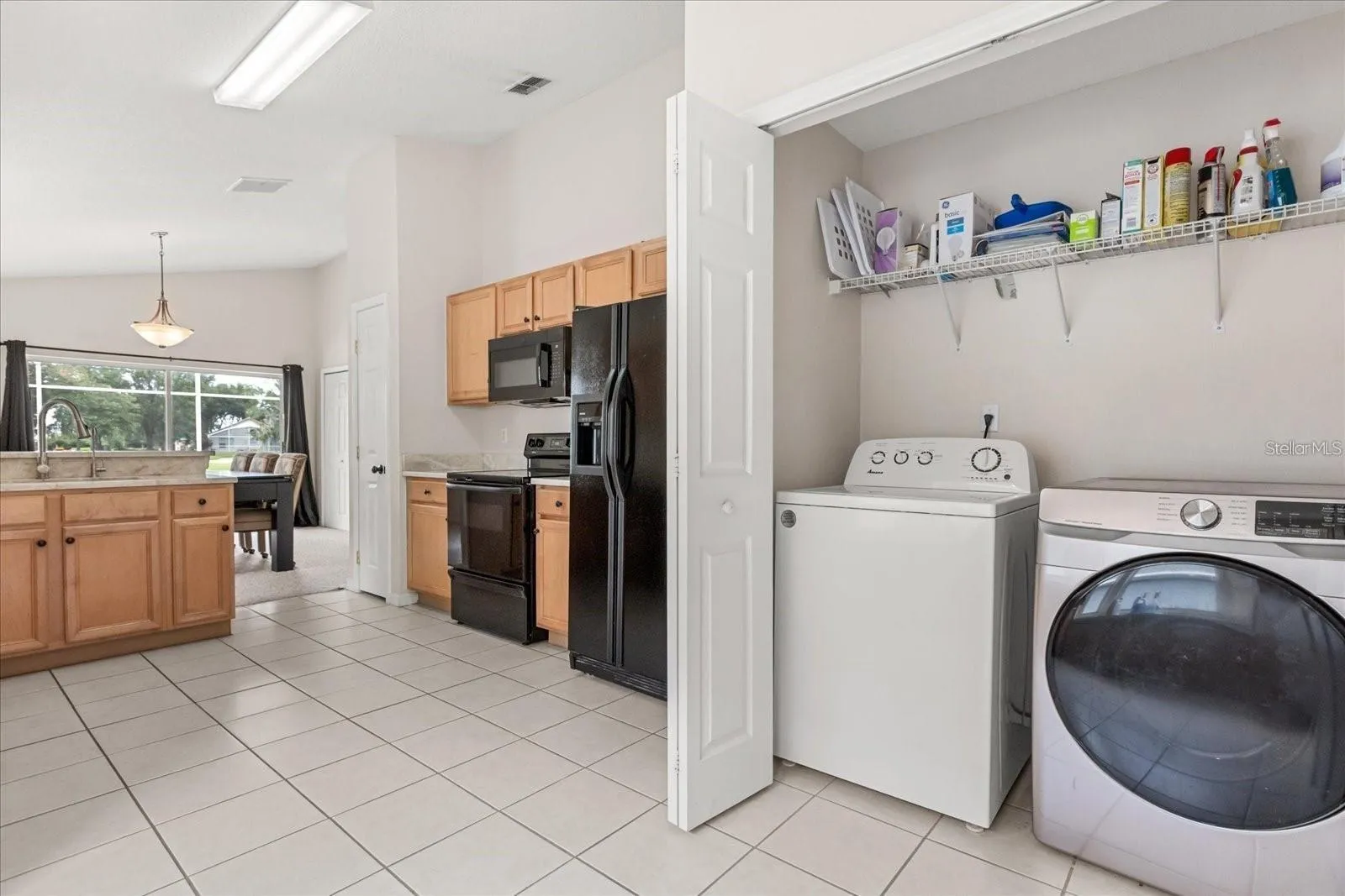 Convenient laundry area with additional storage shelving