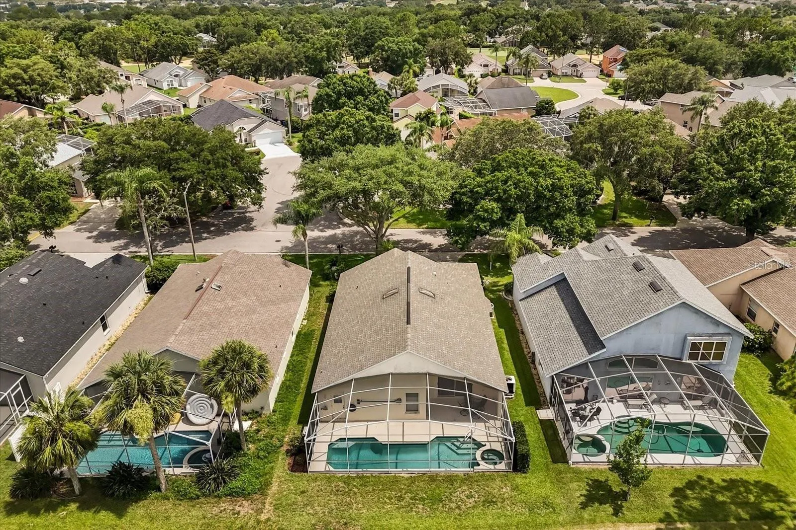 Aerial view showcasing the screened pool and surrounding backyard