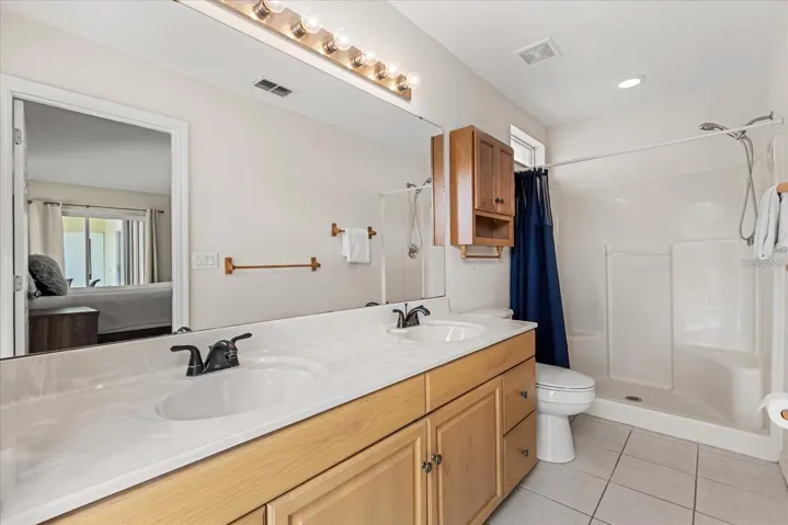 Primary bathroom featuring a garden tub, separate shower, and dual sink vanity