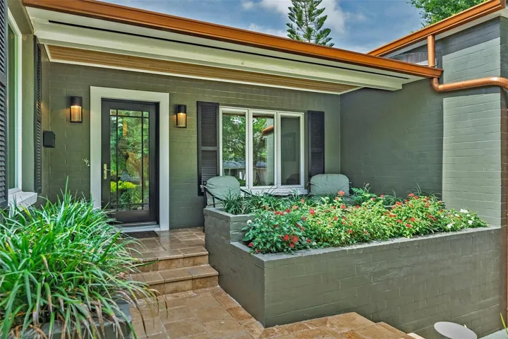 Covered front porch with tongue & groove ceilings and travertine flooring