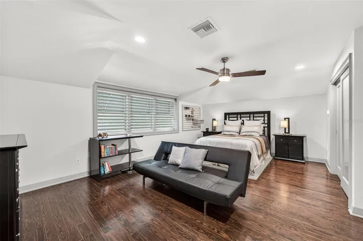 Spacious & Private Guest Bedroom with wood floors, recessed lighting & lots of windows