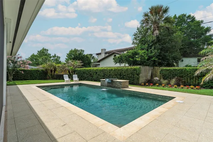 Pool with stacked stone cascading water feature