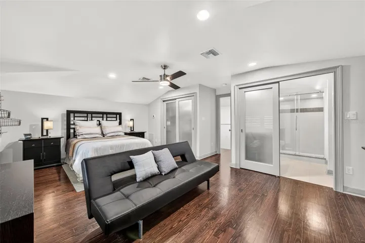 Guest bedroom offers large customized closet with frosted closet doors