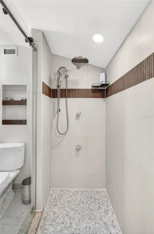 Guest large walk in shower with multiple shower heads and body jets
