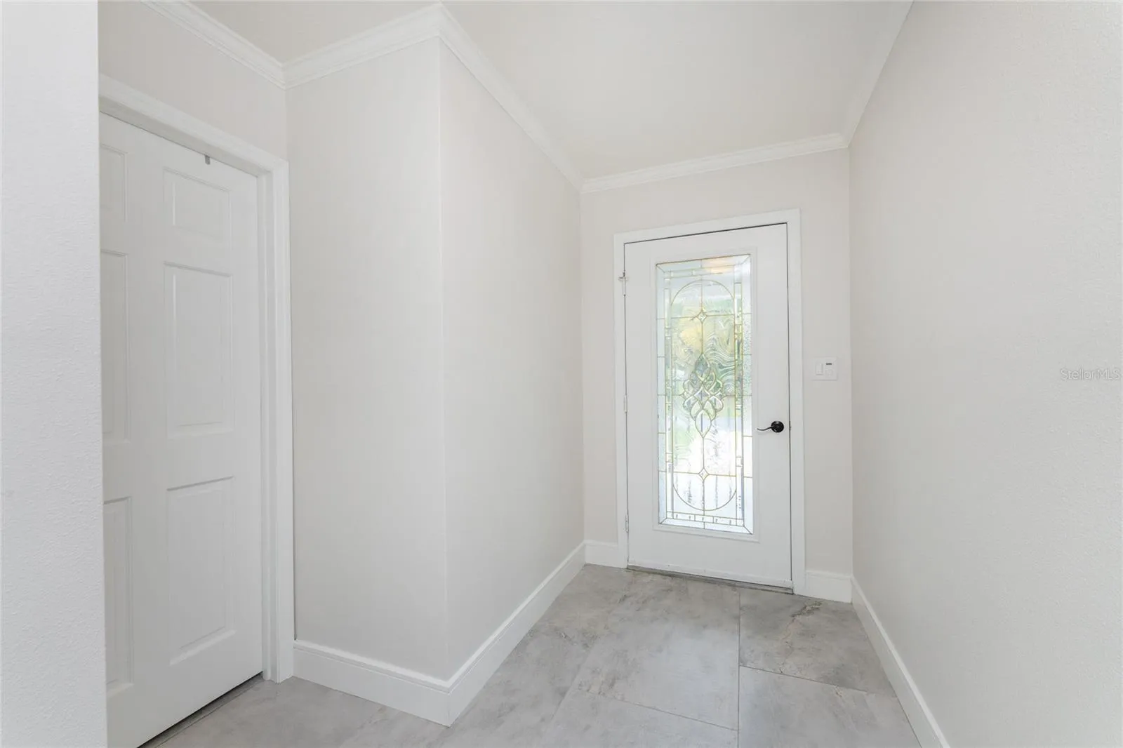 Looking at front door. 2nd bedroom to the left.