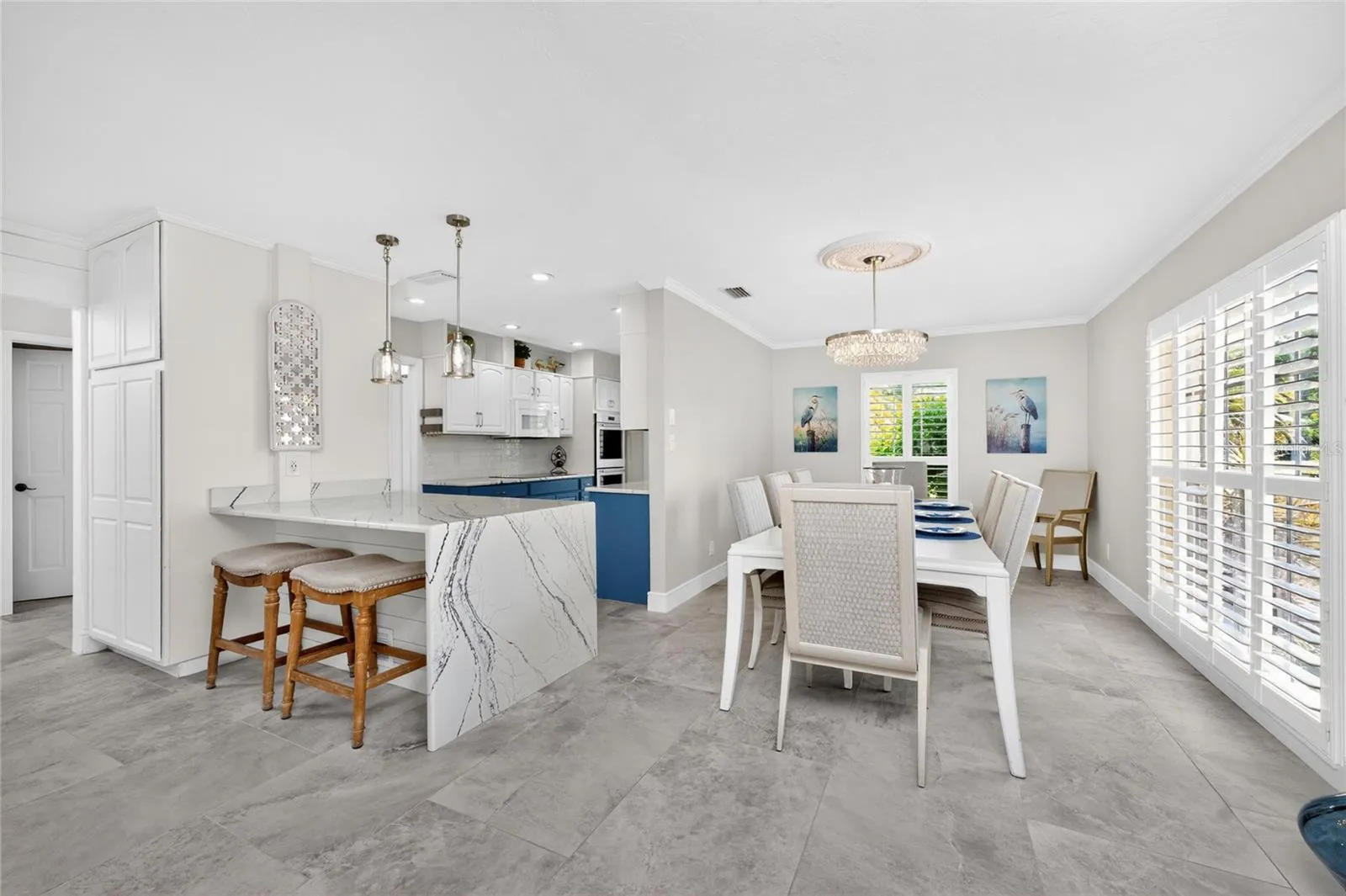 The idea open concept layout effortlessly connects the kitchen breakfast bar to a bright spaacious, bright dining area perfect for entertaining.