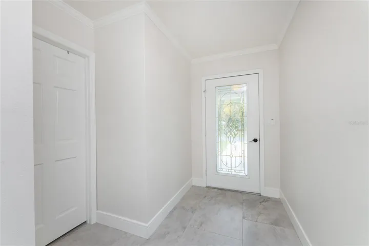 Looking at front door. 2nd bedroom to the left.