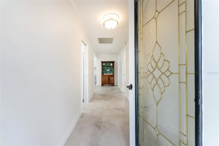 Striking decorative glass front door welcomes you into an inviting foyer featuring beautiful tile flooring.