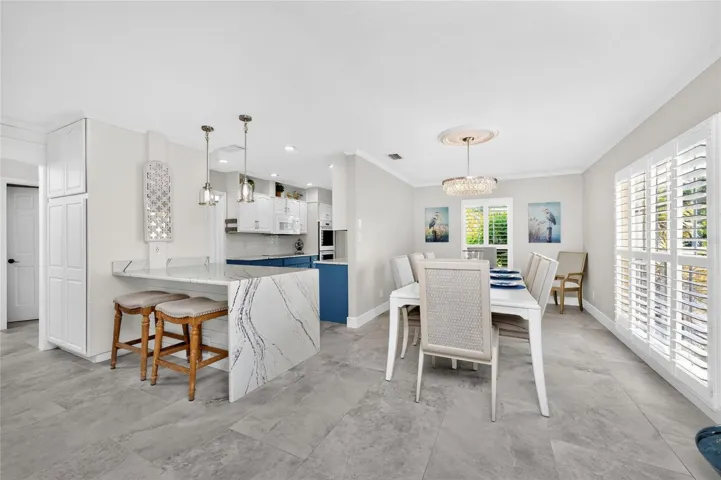 The idea open concept layout effortlessly connects the kitchen breakfast bar to a bright spaacious, bright dining area perfect for entertaining.
