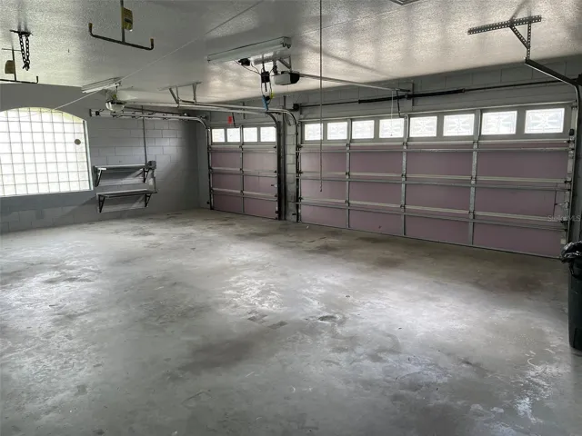 OVERSIZED three car garage 25 FT X 32 FT with Gladiator Wall cabinets and shelves.
