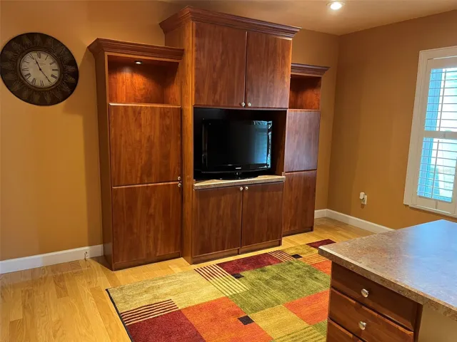 Bedroom 4:  This bedroom has a walk in closet and is set up to be an office with two desks and a wall unit with a TV in it.  This is a great place to homeschool or for someone who works at home.  There is plenty of storage.  And of course there is a ceiling fan.