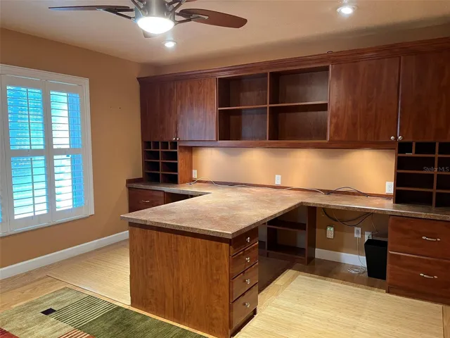 Bedroom 4:  This bedroom has a walk in closet and is set up to be an office with two desks and a wall unit with a TV in it.  This is a great place to homeschool or for someone who works at home.  There is plenty of storage.  And of course there is a ceiling fan.