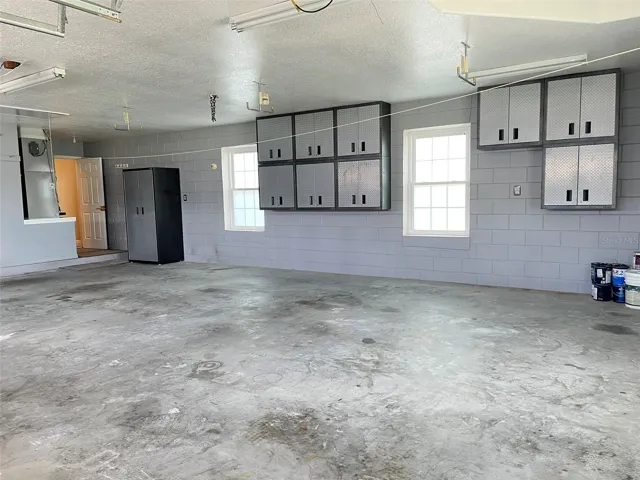 OVERSIZED three car garage 25 FT X 32 FT with Gladiator Wall cabinets and shelves.