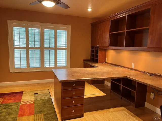 Bedroom 4:  This bedroom has a walk in closet and is set up to be an office with two desks and a wall unit with a TV in it.  This is a great place to homeschool or for someone who works at home.  There is plenty of storage.  And of course there is a ceiling fan.
