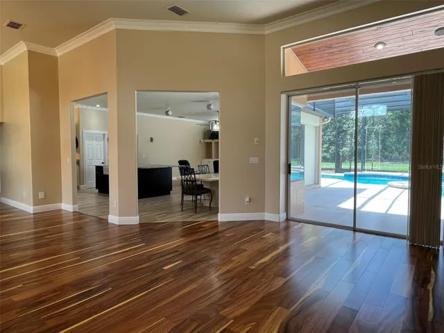 Enter the Double Doors into the foyer and find a view of the pool and yard.
