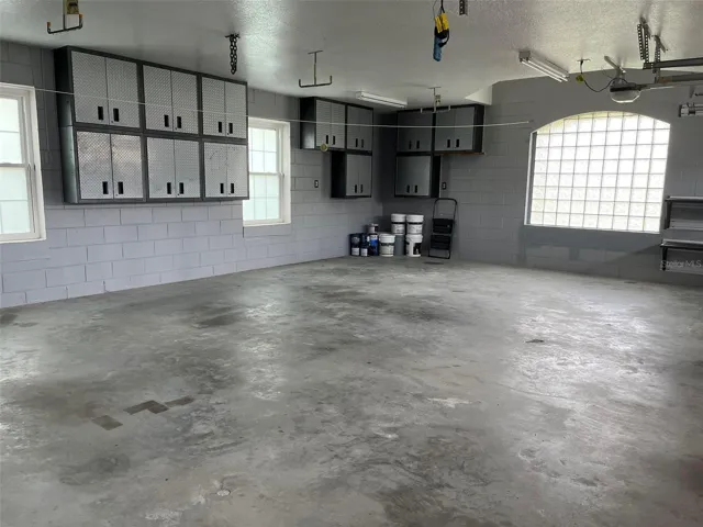 OVERSIZED three car garage 25 FT X 32 FT with Gladiator Wall cabinets and shelves.