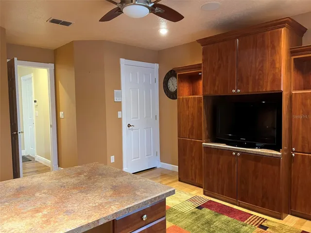 Bedroom 4:  This bedroom has a walk in closet and is set up to be an office with two desks and a wall unit with a TV in it.  This is a great place to homeschool or for someone who works at home.  There is plenty of storage.  And of course there is a ceiling fan.