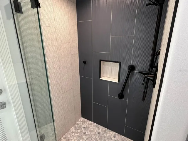 This is the bathroom that has direct entry from Bedroom 2.  It has been fully remodeled.  It has marble floors and counter top, plus lighted and heated mirrors to remove the fog after a steamy shower.