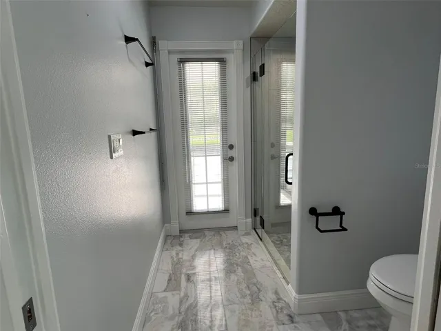 This is the bathroom that has direct entry from Bedroom 2.  It has been fully remodeled.  It has marble floors and counter top, plus lighted and heated mirrors to remove the fog after a steamy shower.