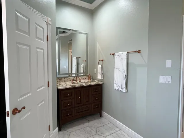 Fully remodeled primary bathroom highlights copper finishes and it is a designers dream.  Two separate vanities with stone counter tops.