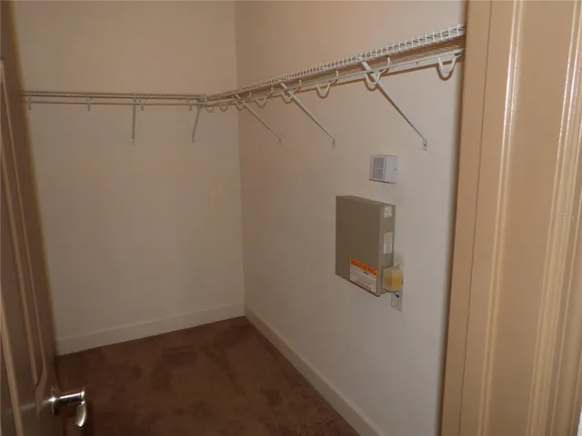 walk in closet of primary bedroom