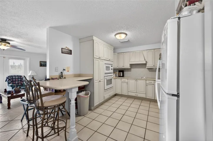 KITCHEN WITH VIEW OF BAR AREA