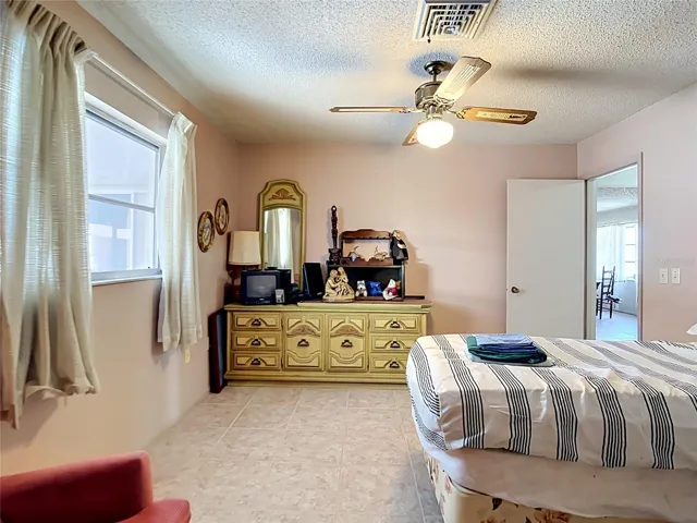 Bright guest bedroom with ceiling fan