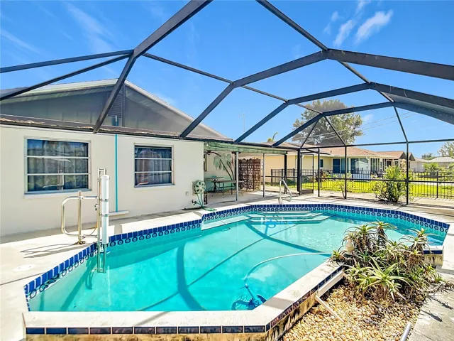 Screen-enclosed pool area with accessibility-friendly features