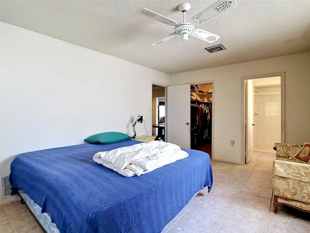 Spacious primary suite with ceramic tile flooring