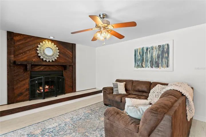 Family room features ceramic tile flooring and ceiling fan