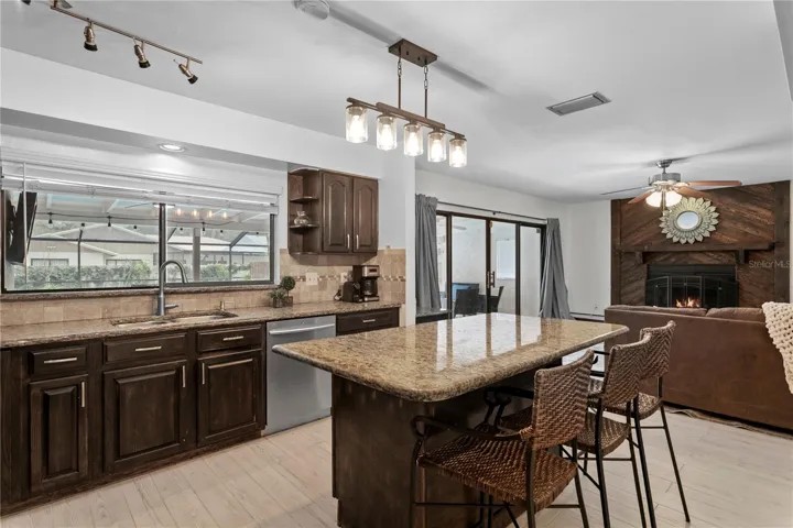 Kitchen features granite counters and a large kitchen island