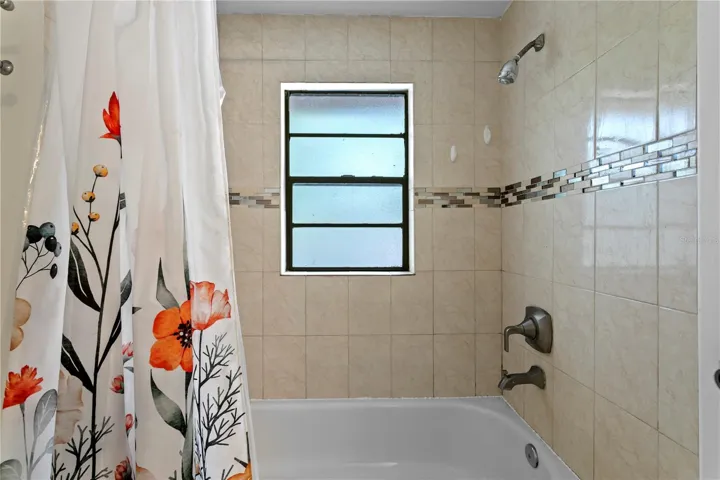 Bathroom 2 with tiled shower and tub