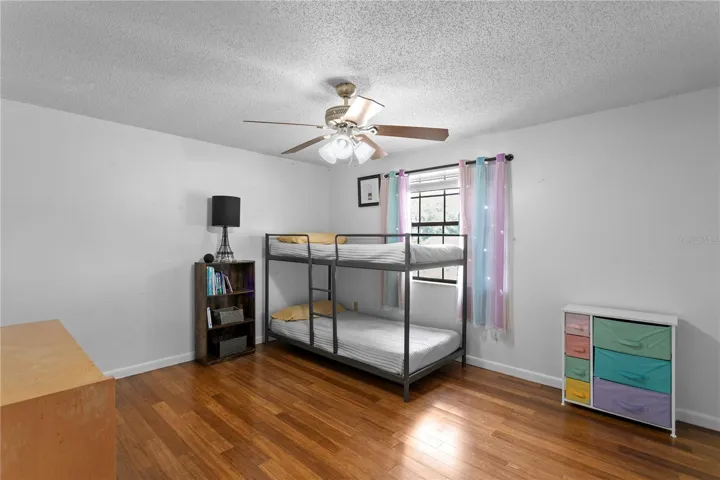 Bedroom 4 with hard wood floor and ceiling fan