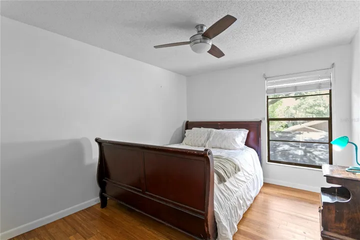 Bedroom 2 with hard wood floors and ceiling fan