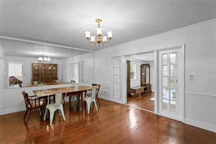 Dining room features hard wood floors and french doors to office