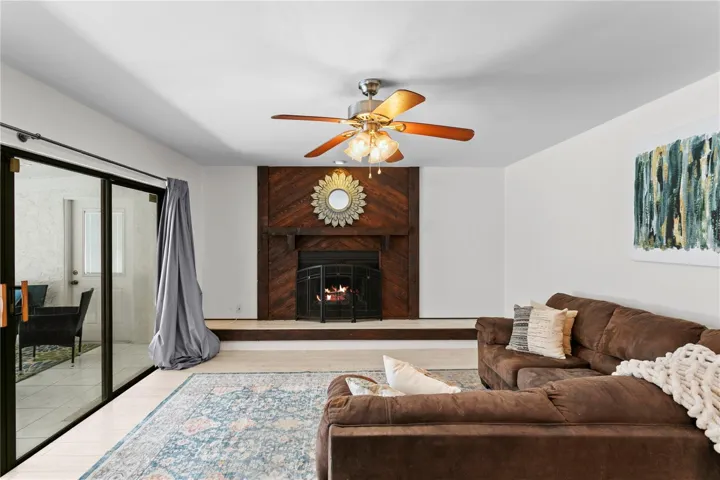 Family room features wood-burning fireplace