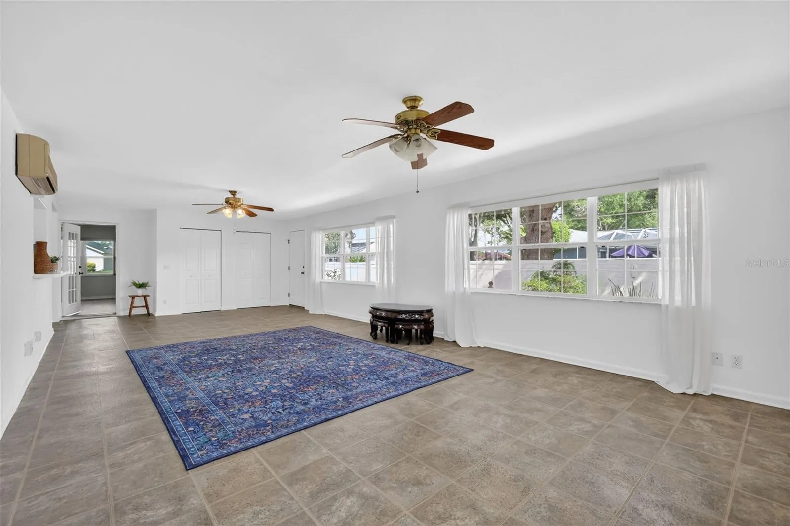 Great room 15x31 flooded with natural light and entrance to court yard.