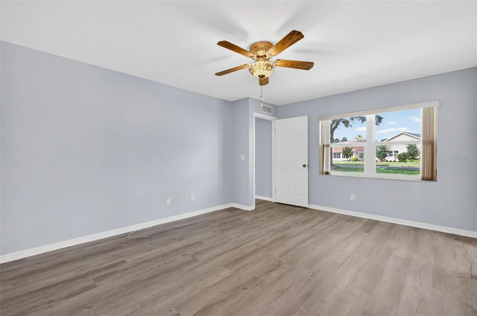 Primary Bedroom 1 features a stained glass ceiling fan/light, walk-in closet, and en suite bathroom.