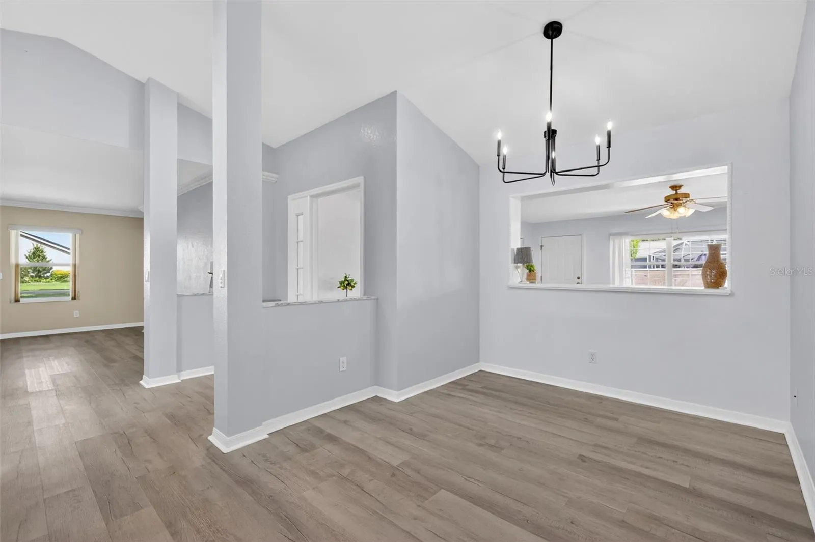 8x12 dining area featuring an upgraded light fixture and convenient pass-through window for easy entertaining.