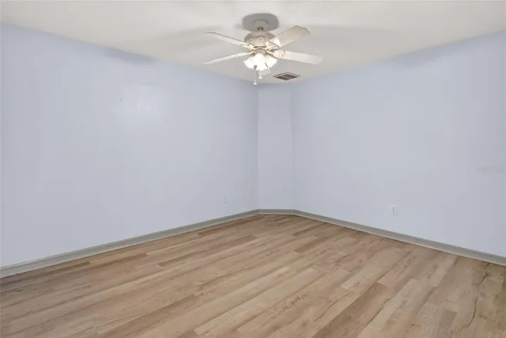 Bedroom 3 with laminate flooring and built in closet.