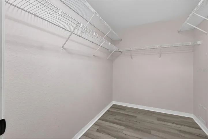 Walk in closet features a solar tube for natural lighting.
