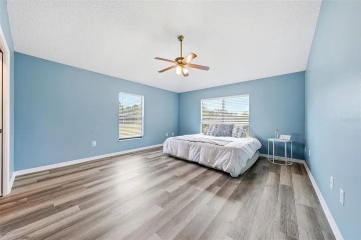 The spacious primary bedroom offers exceptional privacy and is large enough to accommodate an oversized bedroom suite with ease.