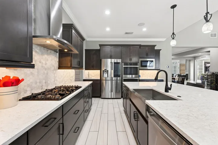 Upgraded stainless steel appliances, including a gas cooktop.