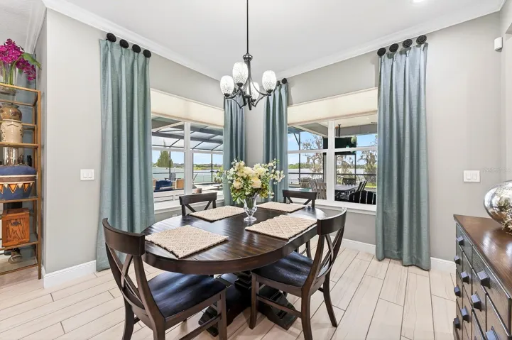 Casual dining with a view of the pool and lake beyond.
