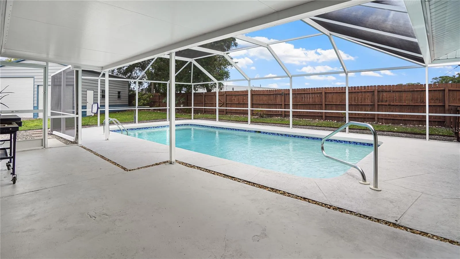Covered lanai and vaulted screened enclosure.
