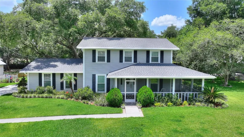 Front exterior.  Home features a wrap around screened front porch.