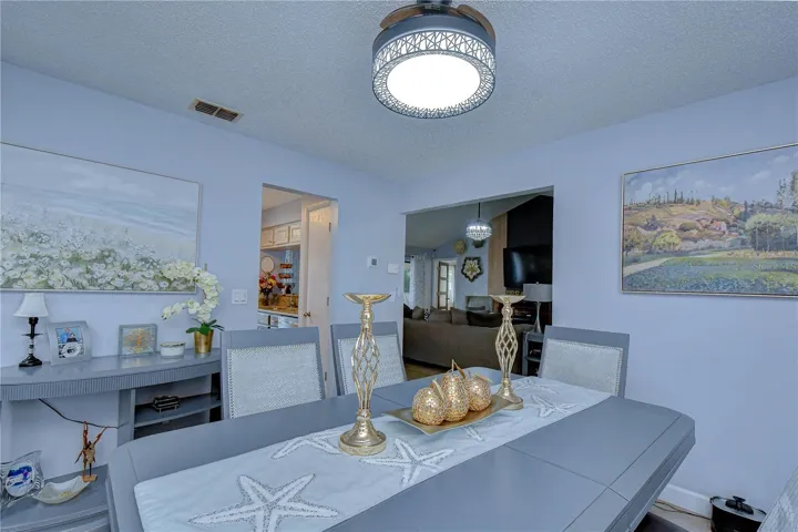 View from behind dining area toward kitchen entry and living room