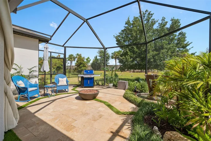 A Beautiful Screened Lanai Extension featuring Travertine Floors, Firepit and a Fountain.