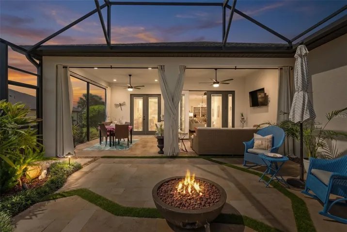 A Beautiful Screened Lanai Extension featuring Travertine Floors, Firepit and a Fountain.